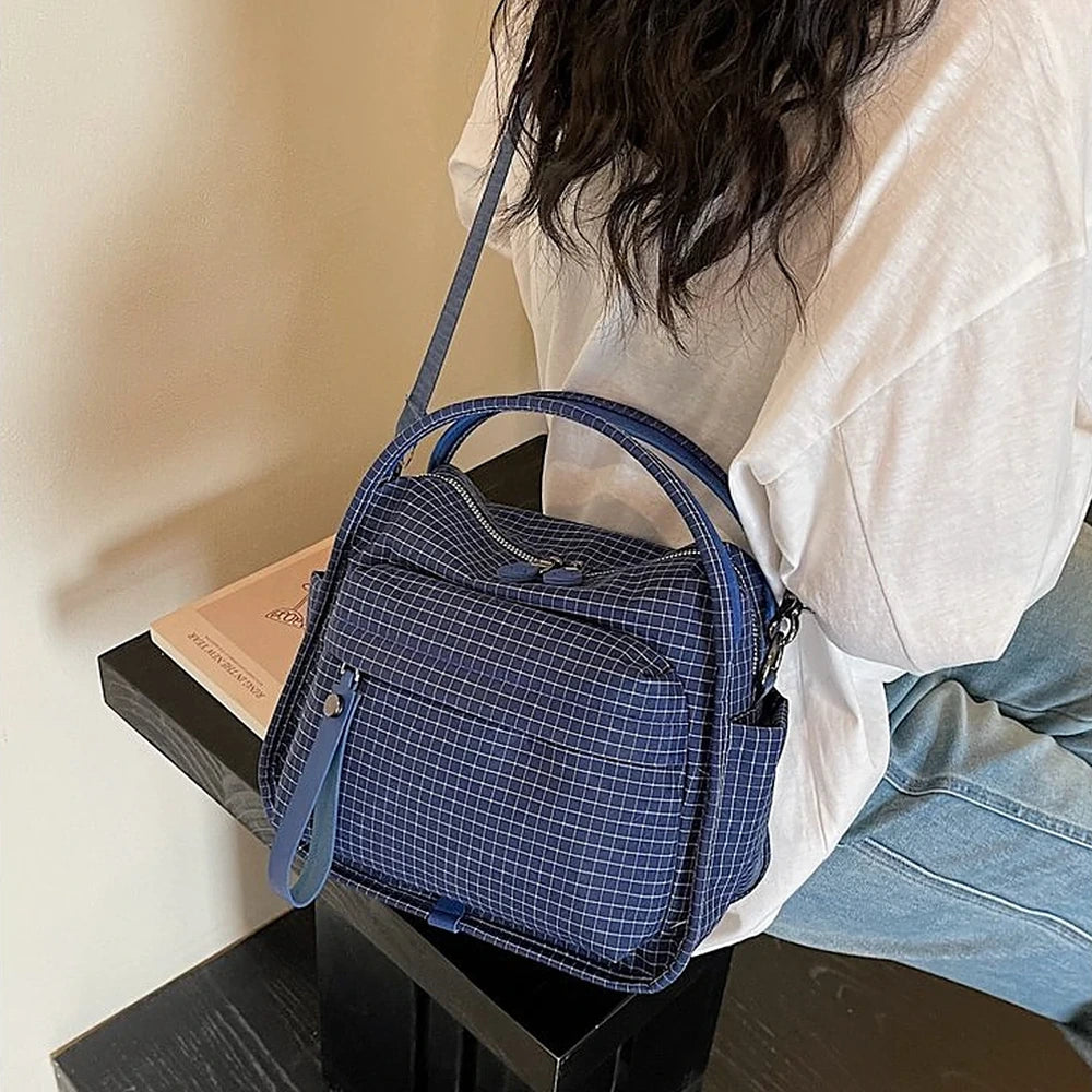 Lyona grid fabric crossbody bag with front zip pocket