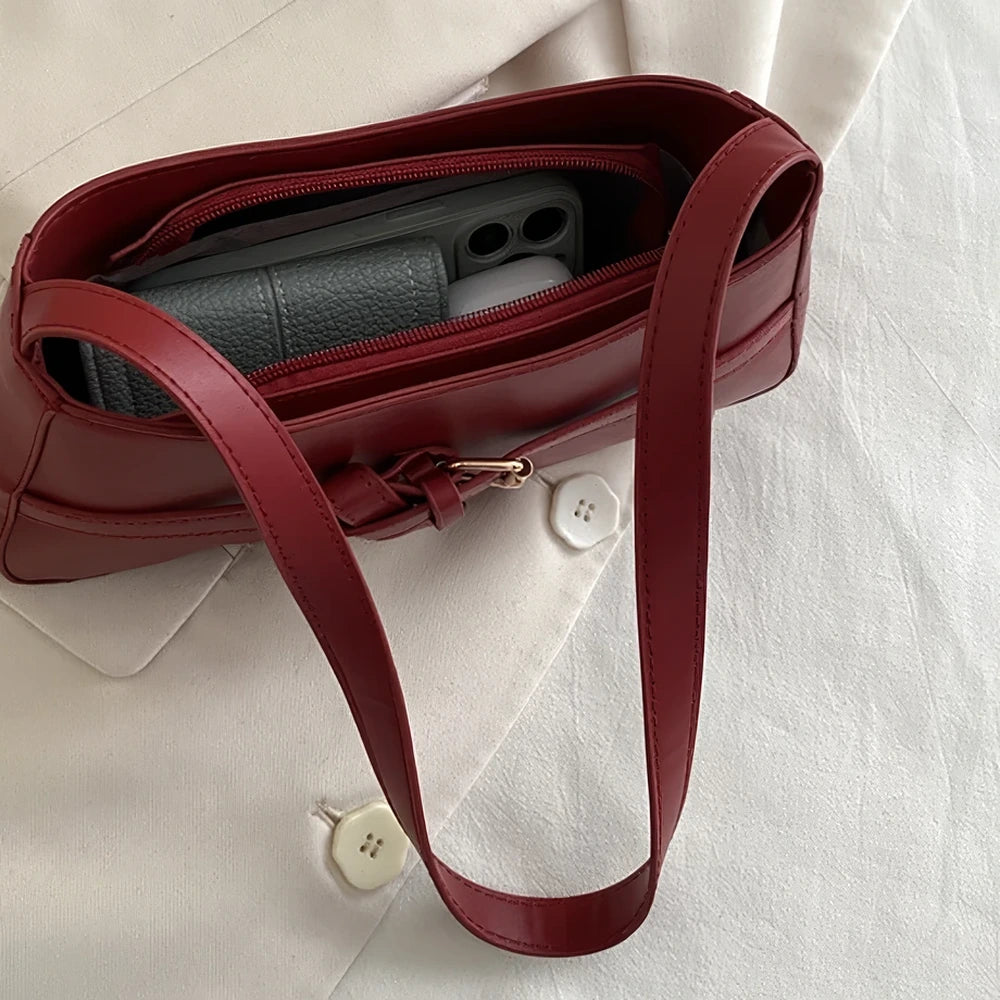 Isla vegan leather shoulder bag with knotted buckle strap