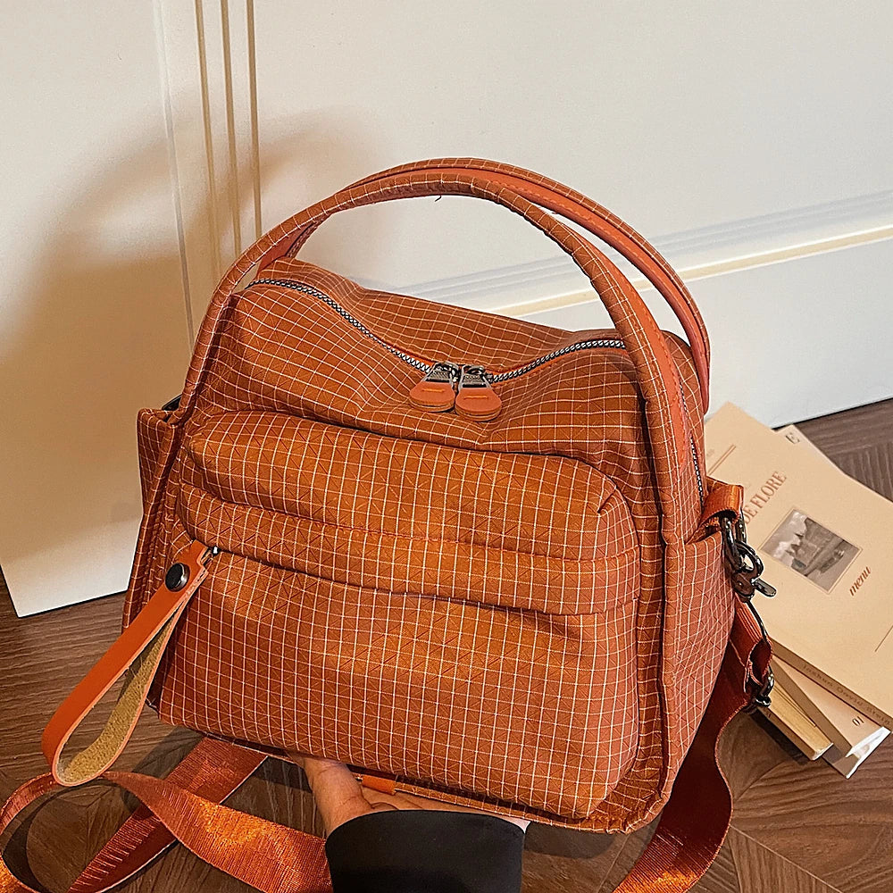 Lyona grid fabric crossbody bag with front zip pocket