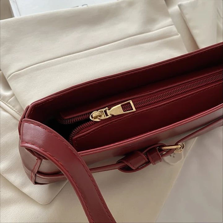 Isla vegan leather shoulder bag with knotted buckle strap
