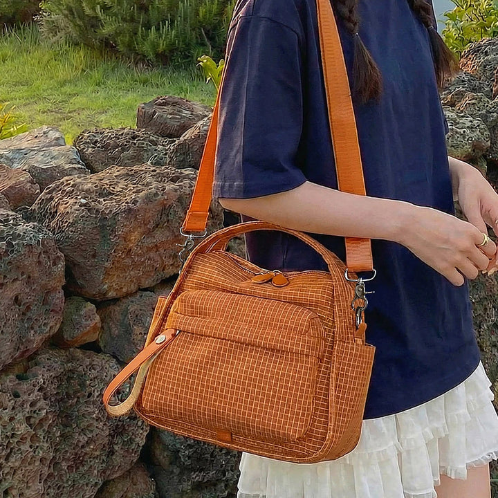 Lyona grid fabric crossbody bag with front zip pocket