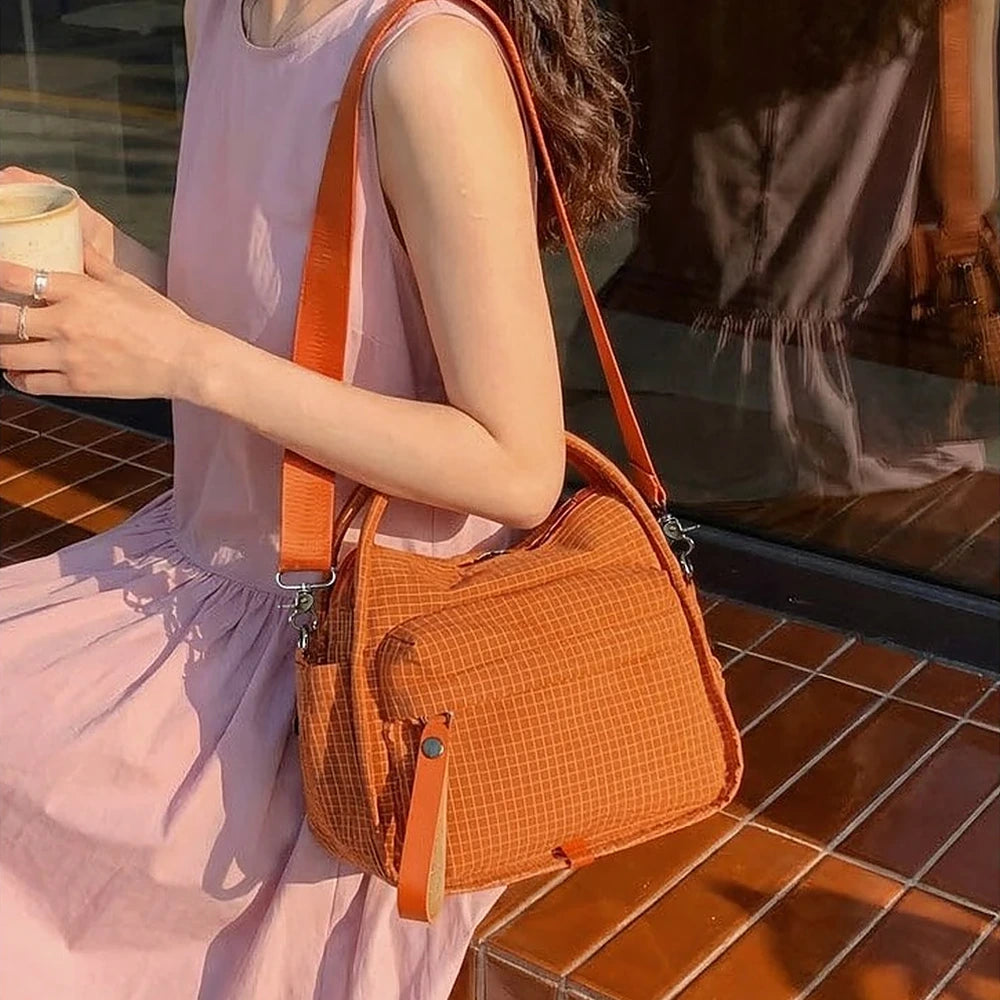 Lyona grid fabric crossbody bag with front zip pocket