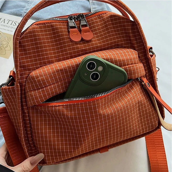 Lyona grid fabric crossbody bag with front zip pocket