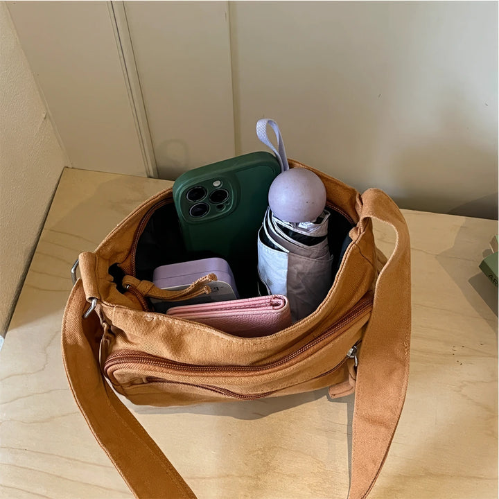 Rina washed canvas crossbody bag with front zip pockets