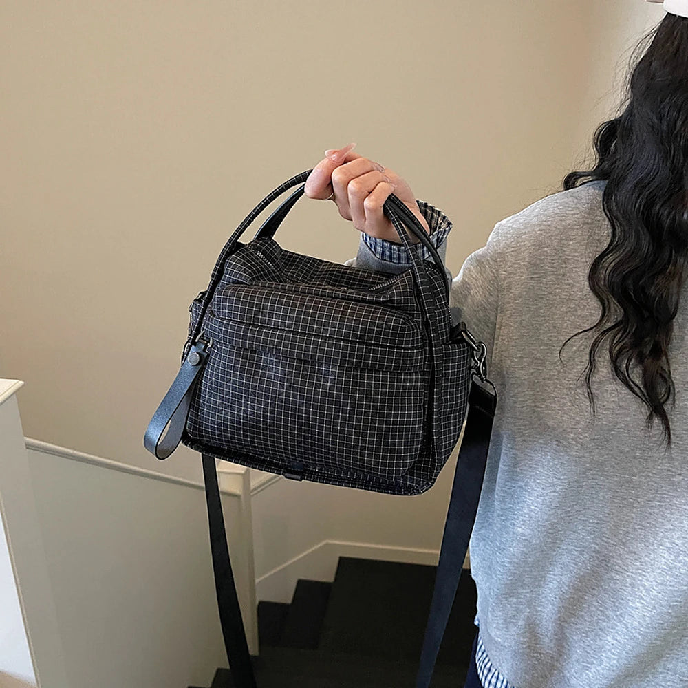 Lyona grid fabric crossbody bag with front zip pocket