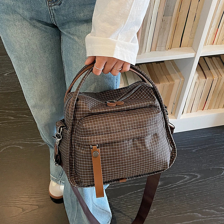 Lyona grid fabric crossbody bag with front zip pocket