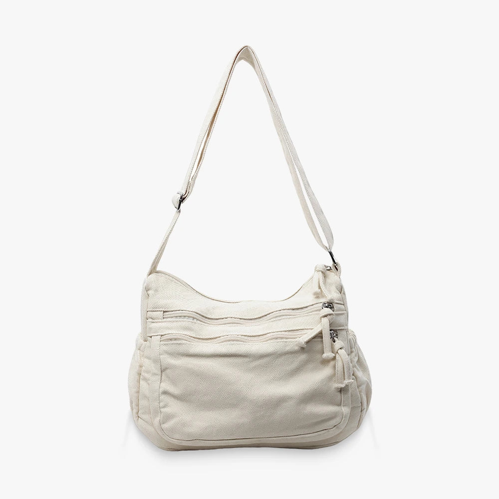 Rina washed canvas crossbody bag with front zip pockets in Beige
