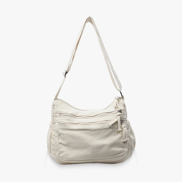 Rina washed canvas crossbody bag with front zip pockets in Beige