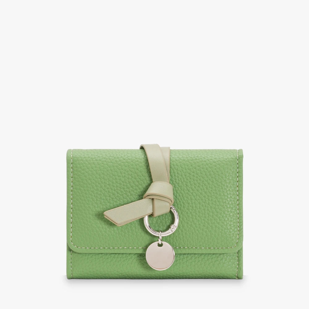 Celia pebbled vegan leather trifold wallet with knotted strap and silver-tone charm in Green