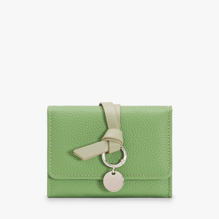 Celia pebbled vegan leather trifold wallet with knotted strap and silver-tone charm in Green
