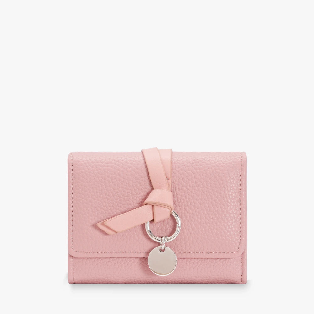 Celia pebbled vegan leather trifold wallet with knotted strap and silver-tone charm in Pink