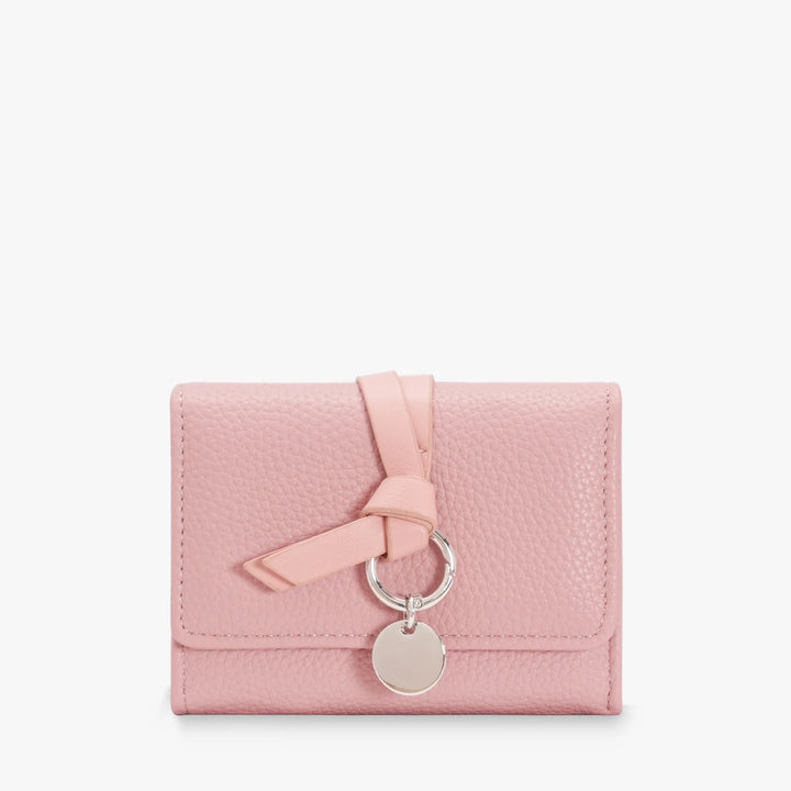 Celia pebbled vegan leather trifold wallet with knotted strap and silver-tone charm in Pink